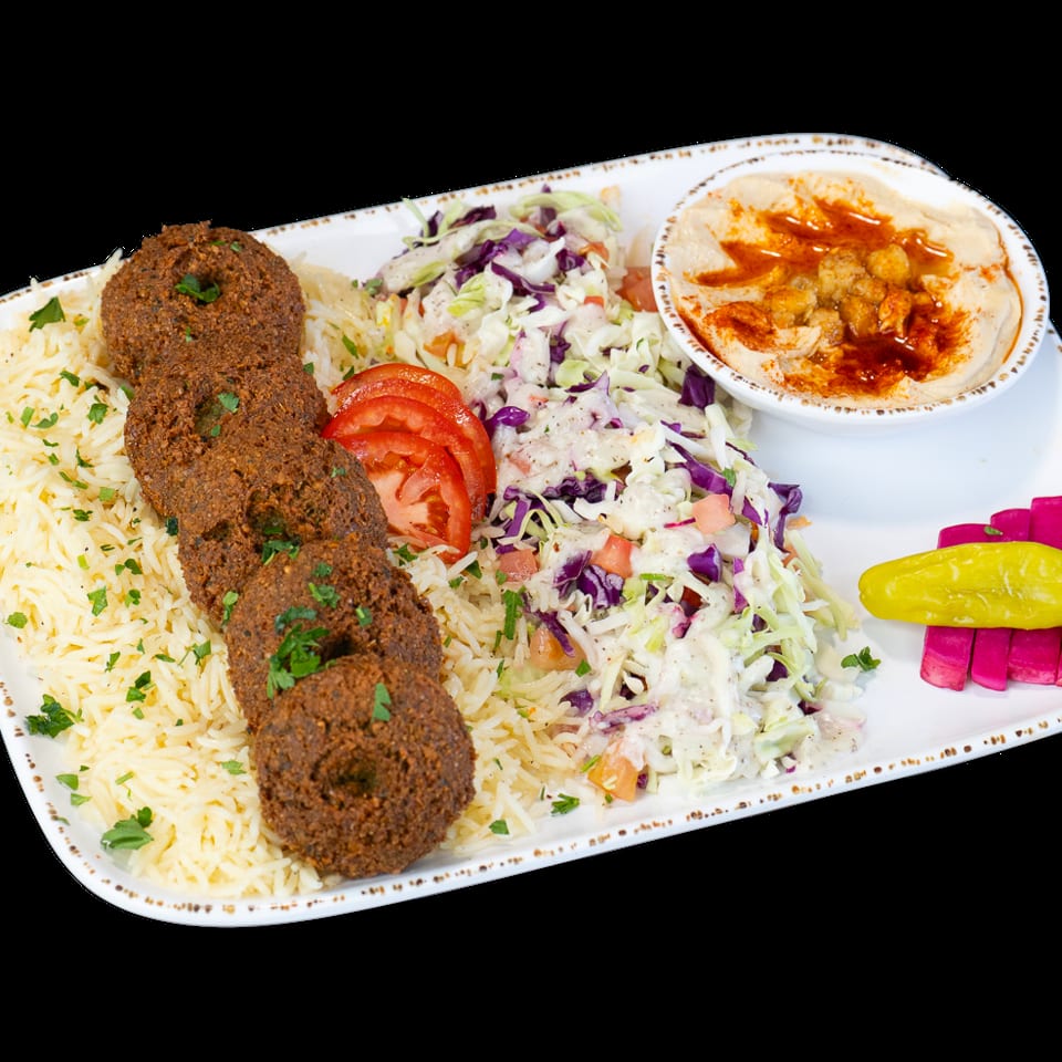 Falafel plate with rice, coleslaw, hummus, sliced tomatoes, pickled turnips, and a yellow pepper.